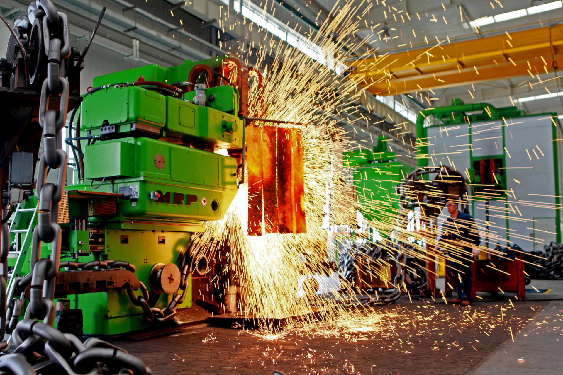 Chain welding in progress in the Ellton workshop, sparks flying from the welder
